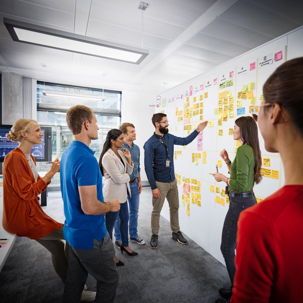 A group of people having a discussion on a board.