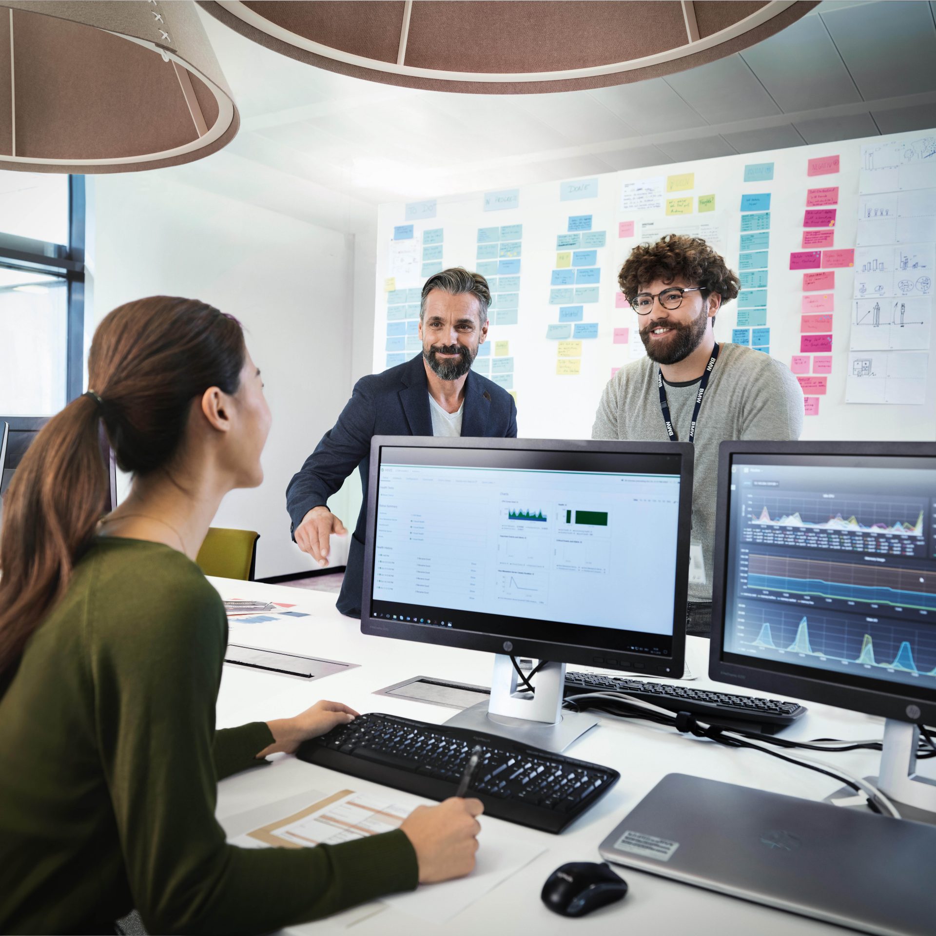 Three professionals are meeting in an office to discuss a new project.