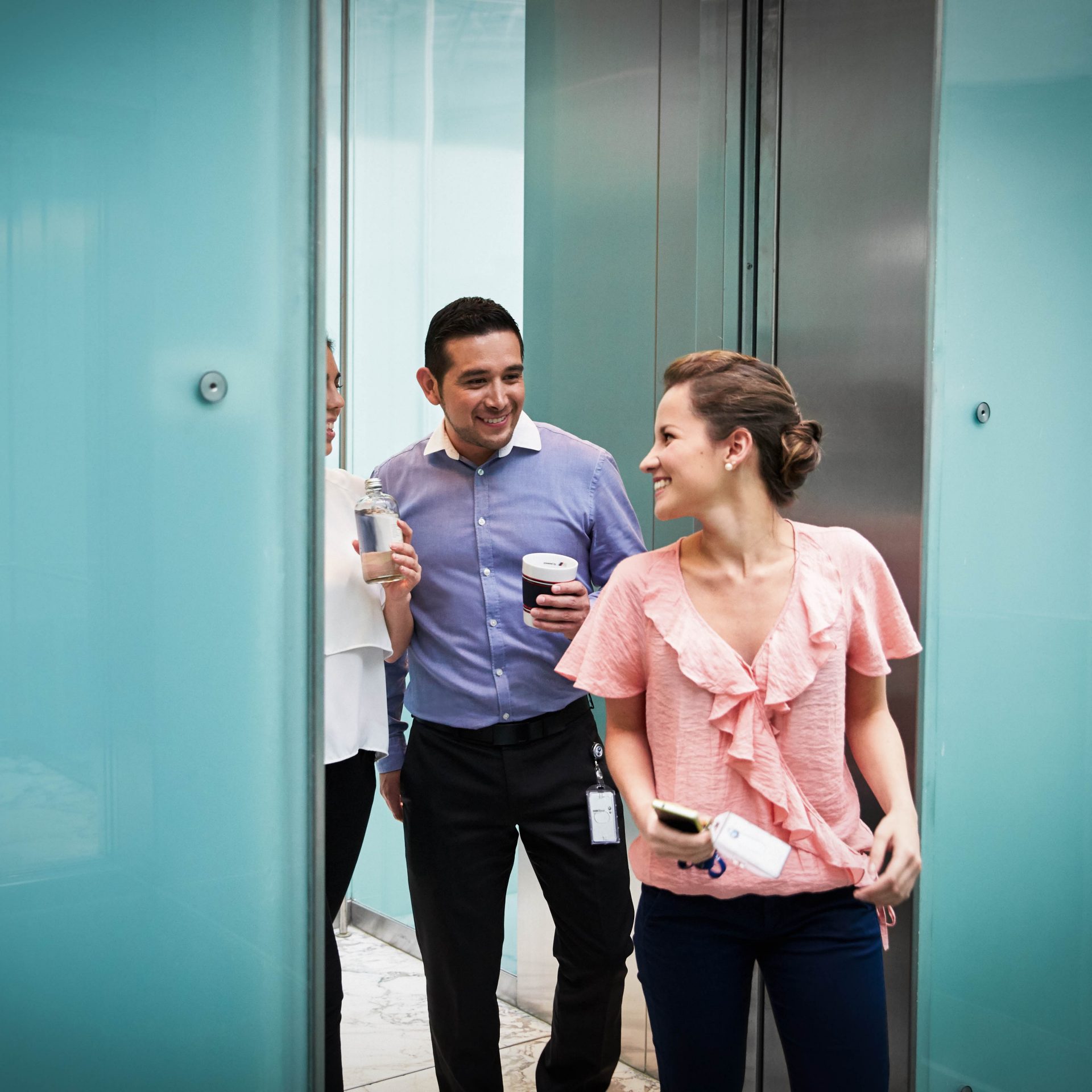 In this picture, a group of BMW employees stepps out of a lift.