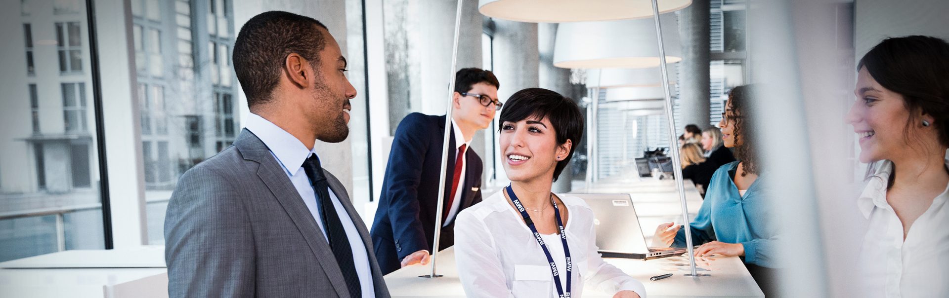 Three BMW employees are having a chat in the office.
