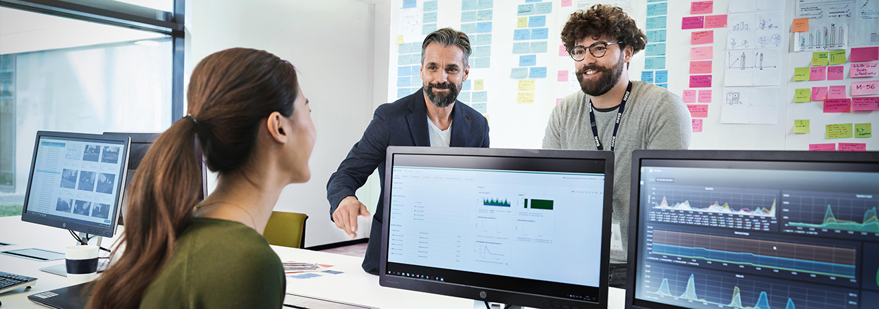 Three BMW professionals, a female one and two male ones, are meeting in an office to discuss a new project.