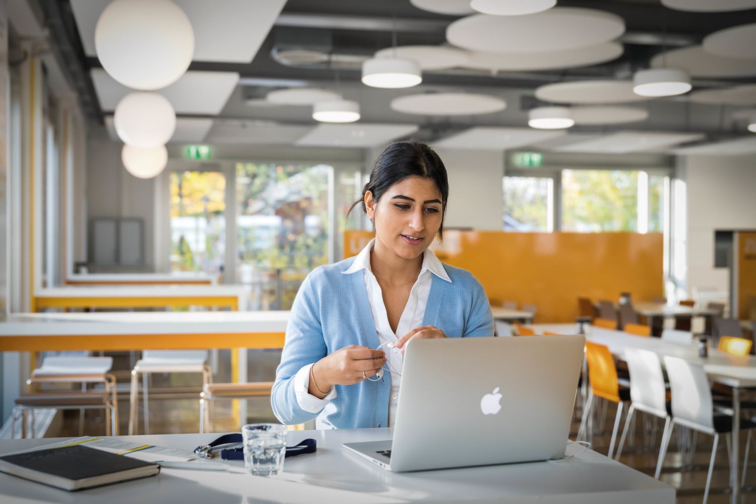 A BMW employee is working with her laptop at an BMW office.