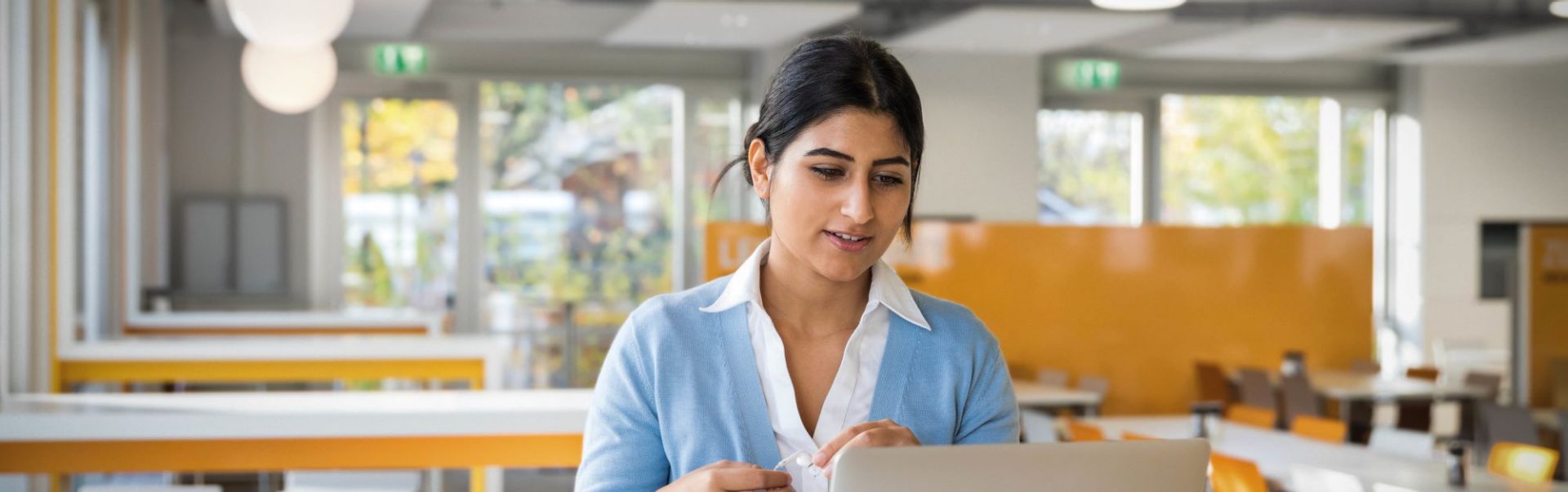 A BMW employee is working with her laptop at an BMW office.