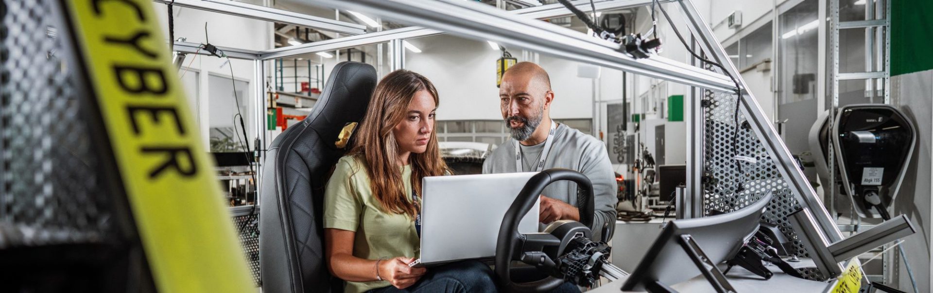 A woman who works in IT Security at BMW discusses something with her colleagues.
