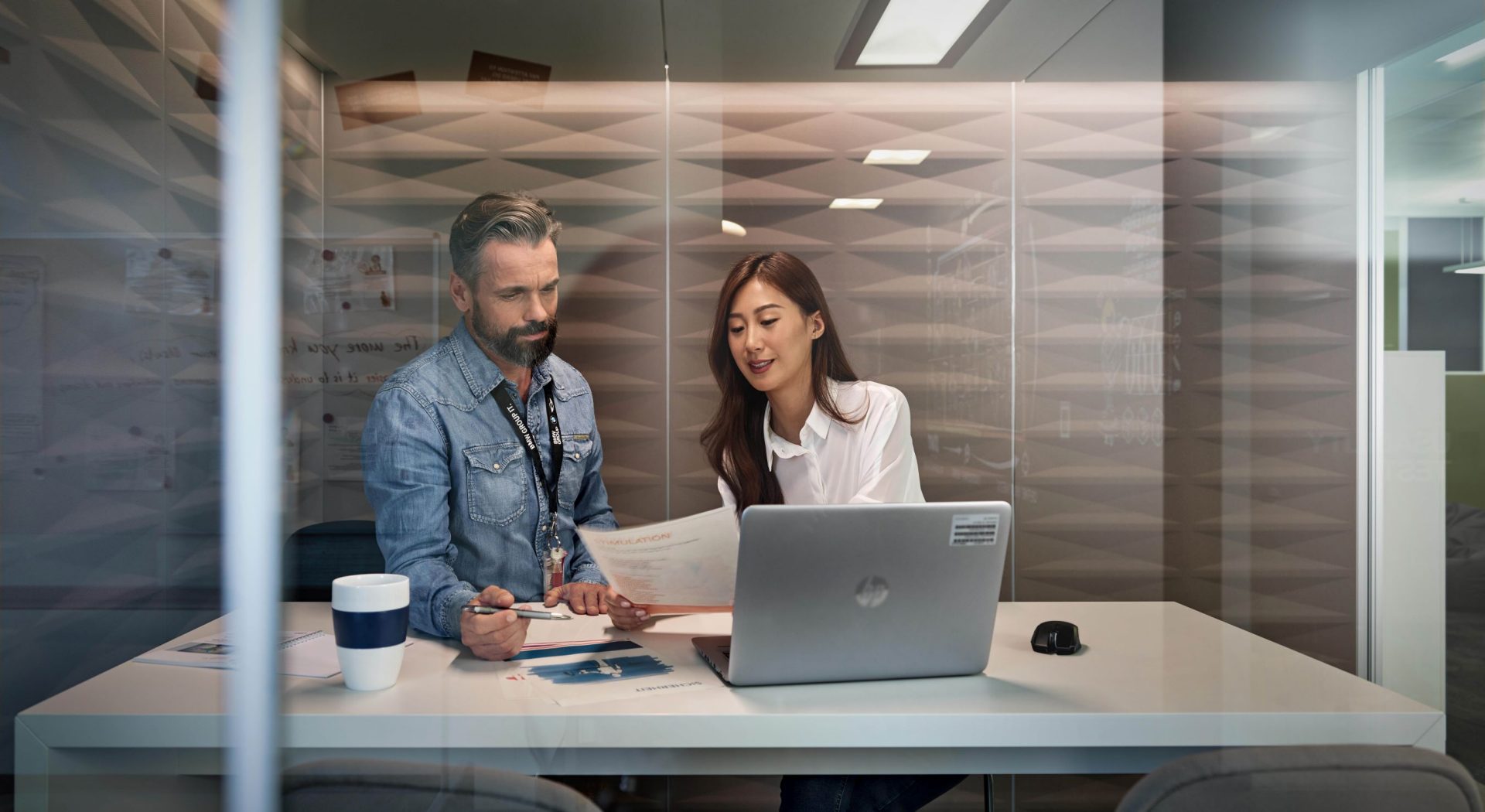 The photo shows a recent graduate and a BMW employee having a meeting.