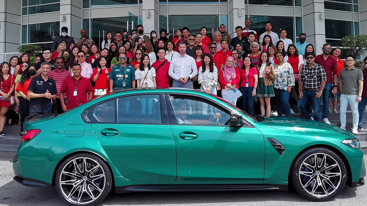 A group of BMW Group Malaysia colleagues in front of the office building.