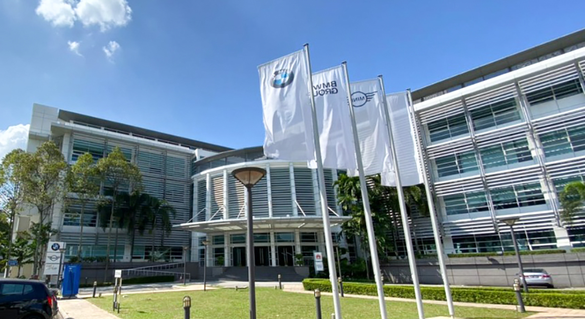 The image shows an BMW Group office building.