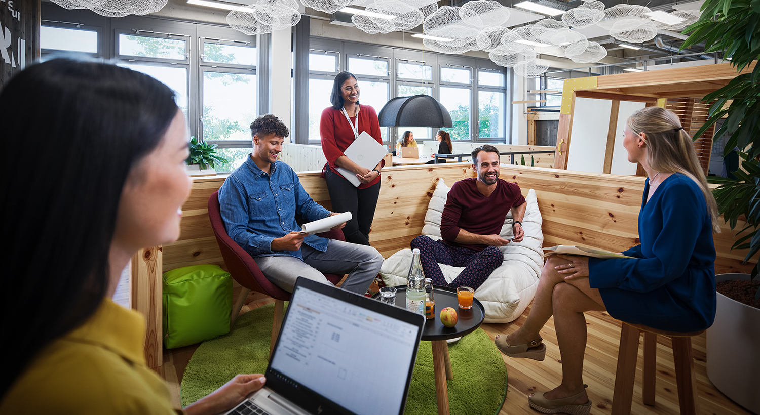 A group of young people are having a conversation in an innovative working environment.