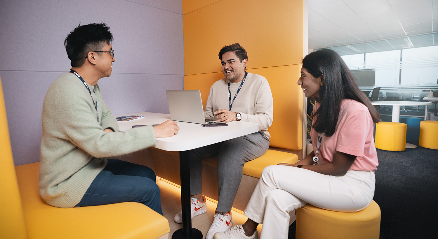 A group of young people are having a conversation in an innovative working environment.