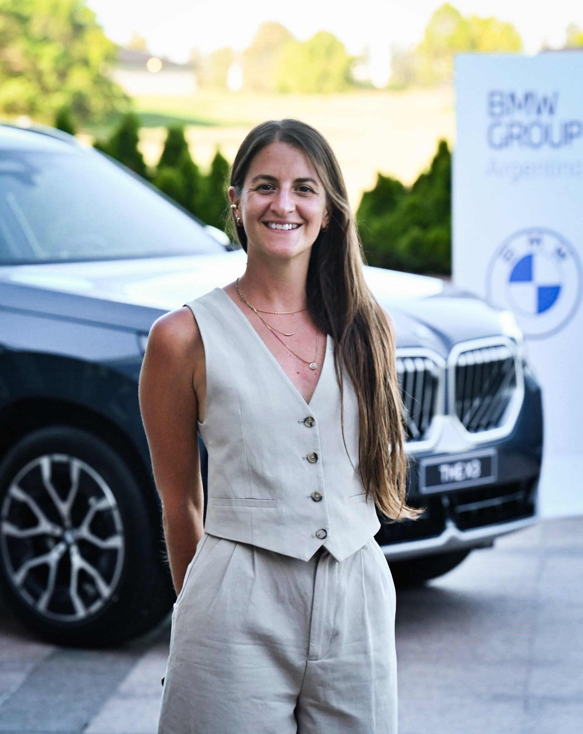 Sofia, BMW Group Argentina employee standing in front of a BMW X3