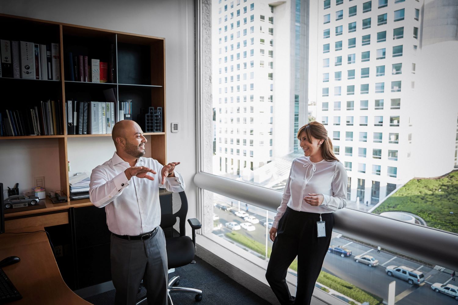 Two Marketing colleagues in the office talking about their work.