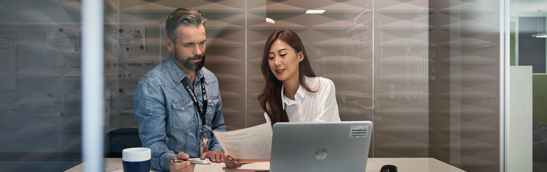 Intern with her supervisor in a meeting room.
