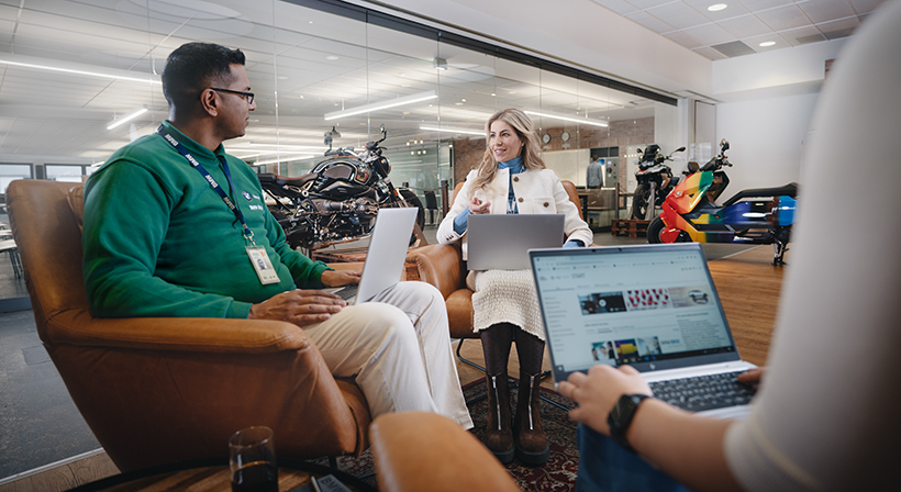 In this picture, a female professional explains the benefits of a BMW career to a young man.