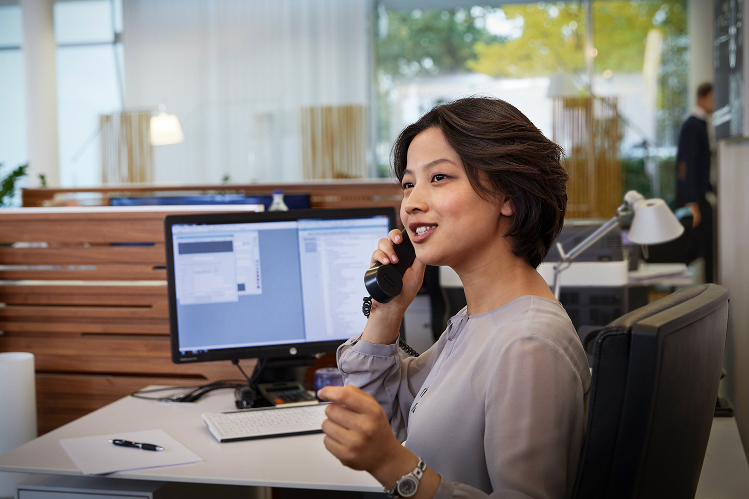 A woman having a phone call with a customer