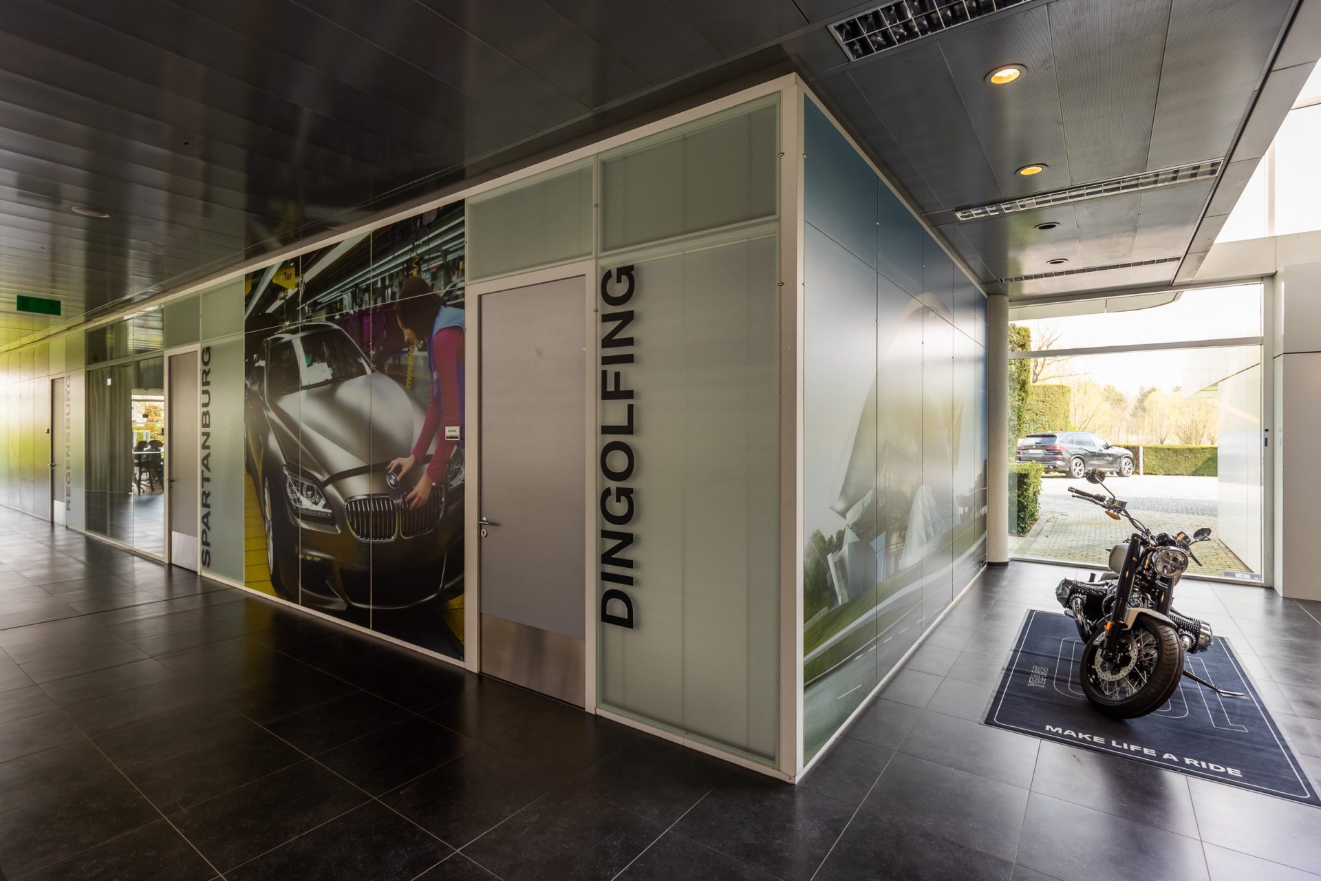 A glimpse inside a BMW car dealership featuring a BMW motorcycle.