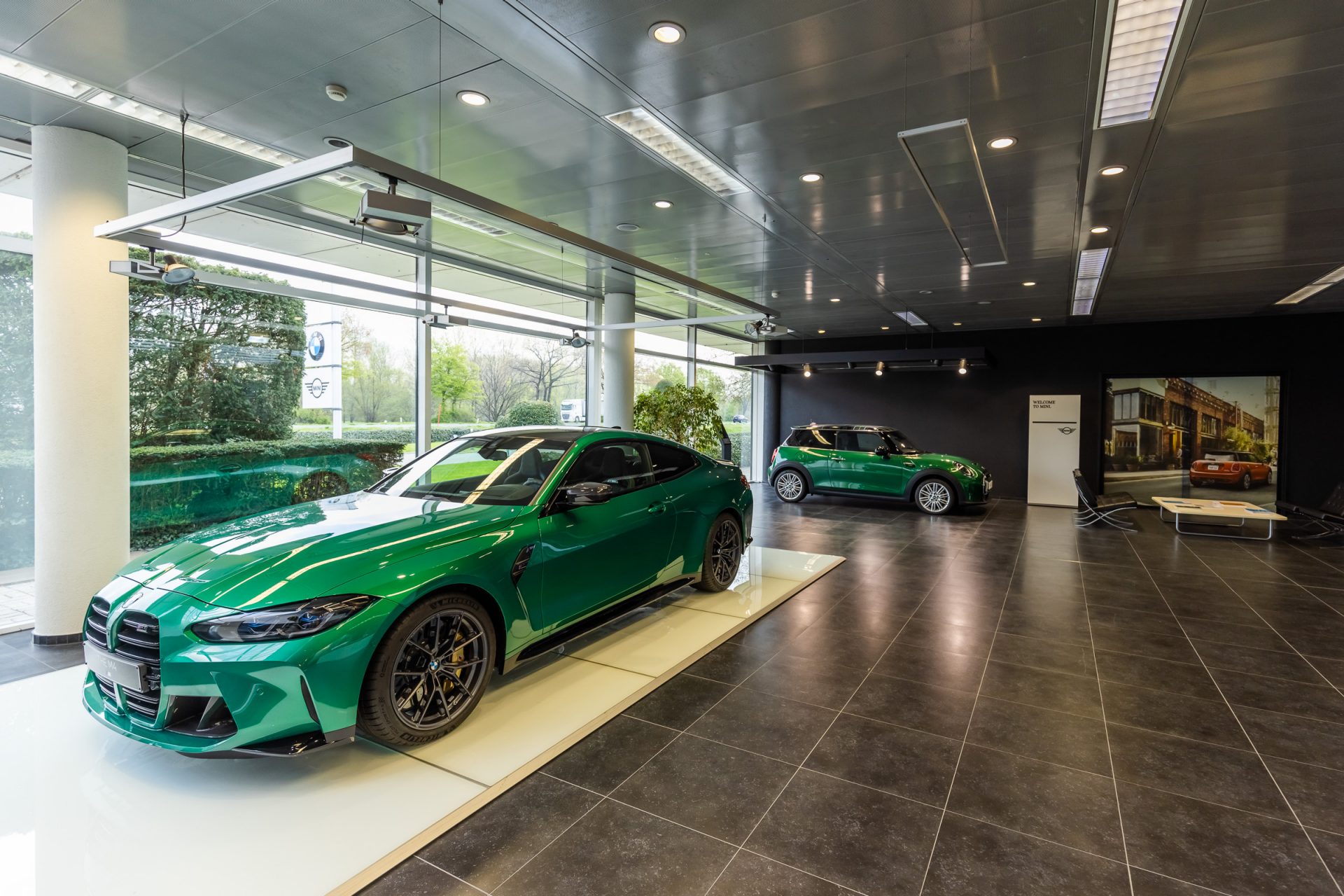 A glimpse inside a BMW dealership featuring a green BMW and MINI.