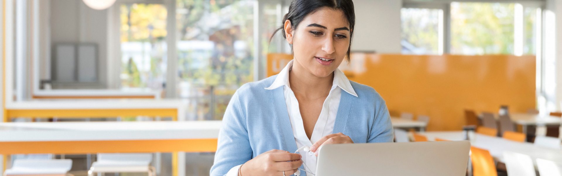 a young woman working on her laptop at a BMW office