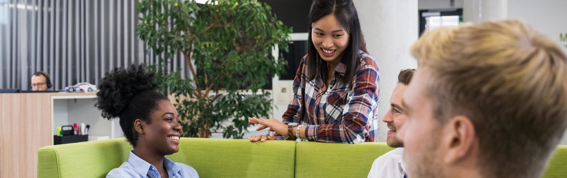 A few young BMW Employees have a chat in a modern office environment.
