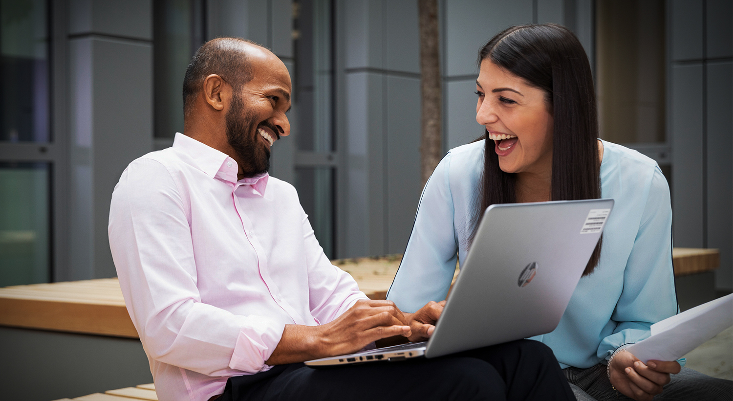 In this picture, a female professional explains the benefits of a BMW career to a young man.