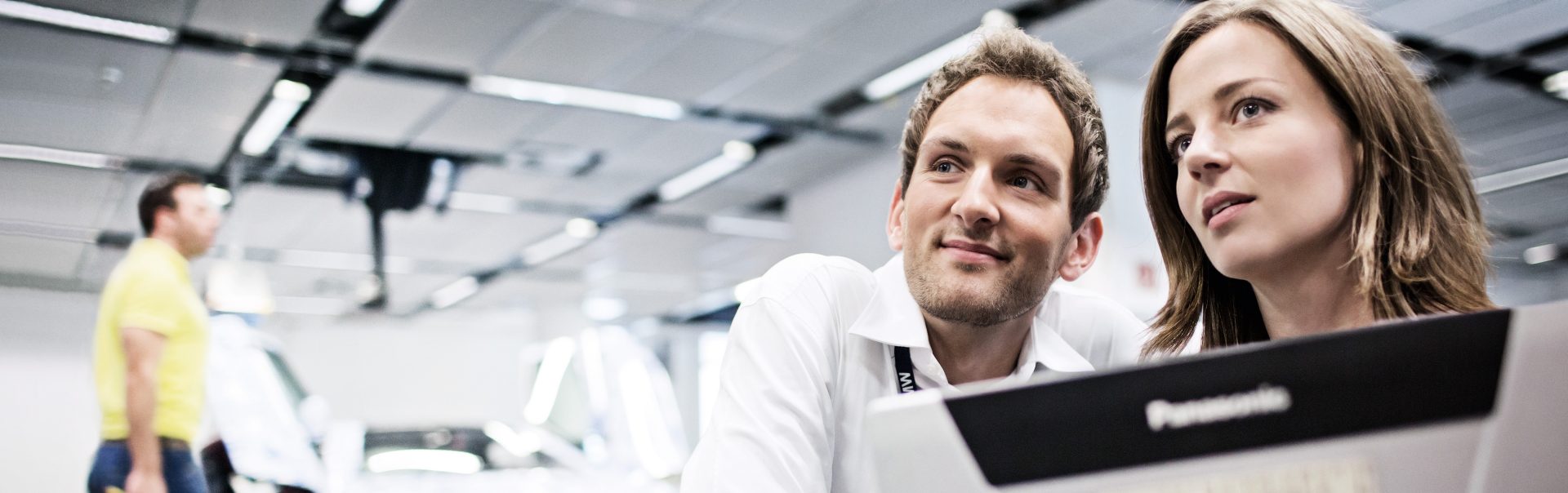 In the picture, two BMW professionales are working together.