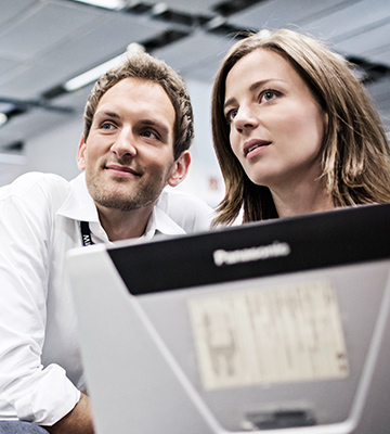 In the picture, two BMW professionales are working together.