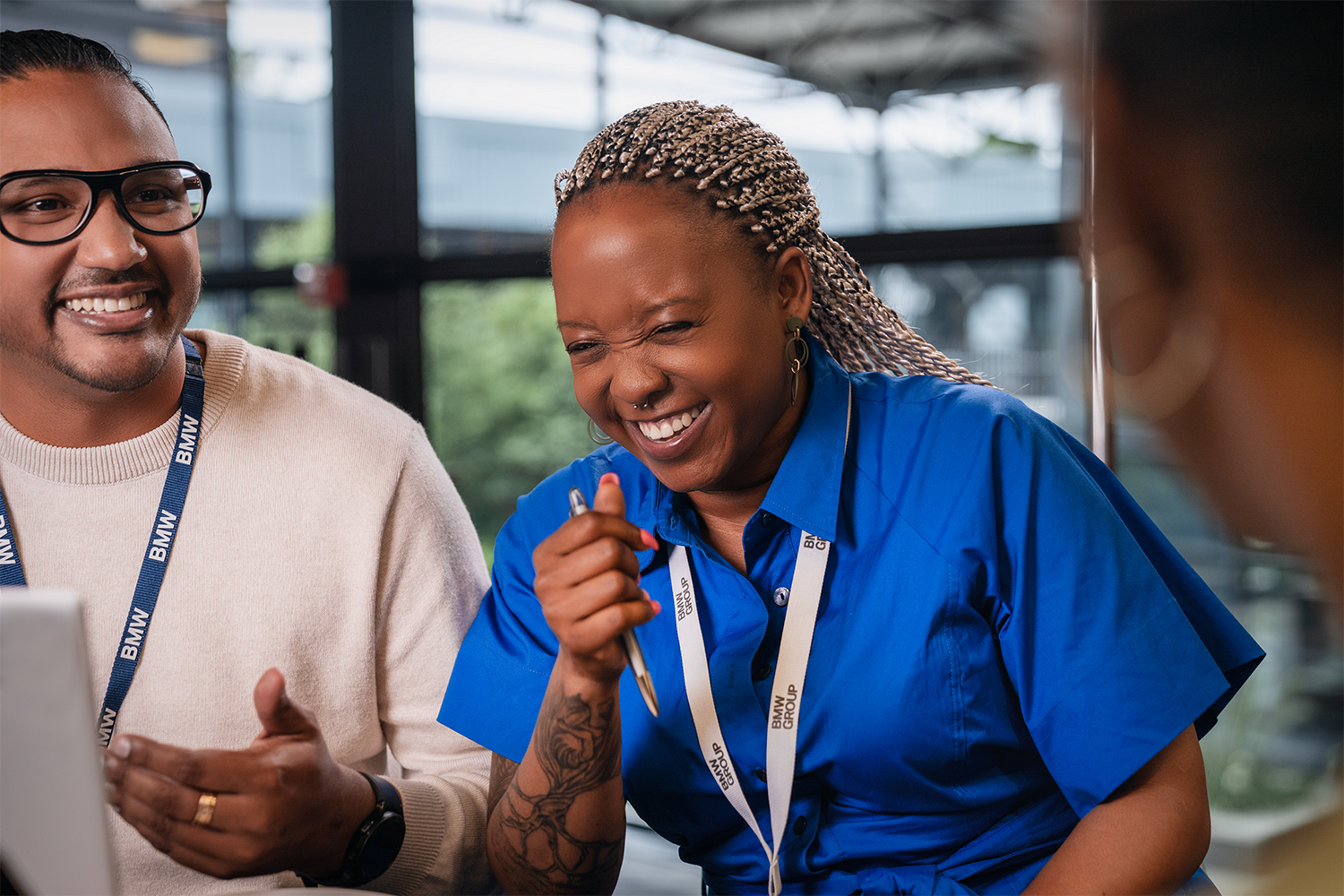 The picture represents the job culture by showing two BMW production employees.