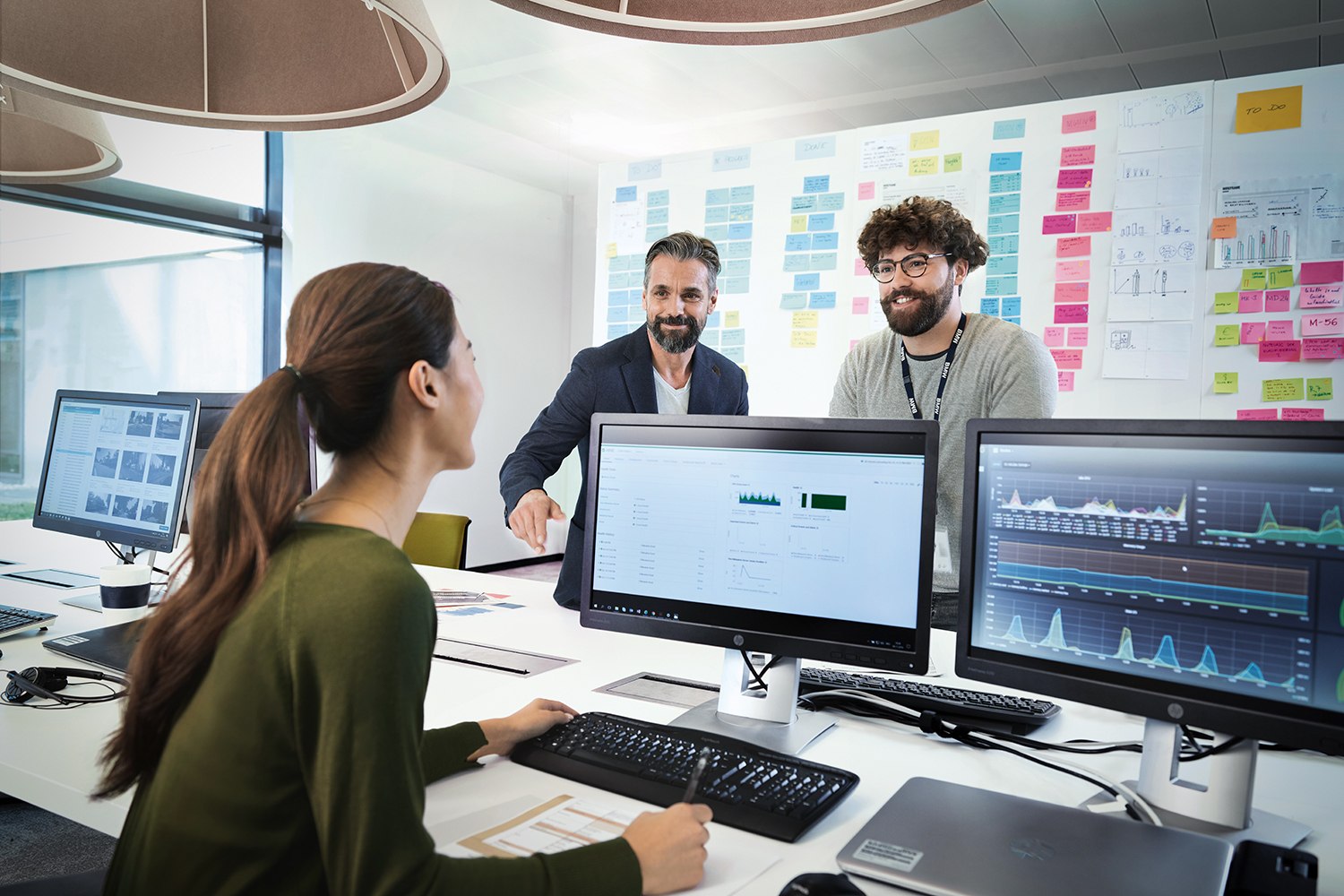 Three IT colleagues analysing data