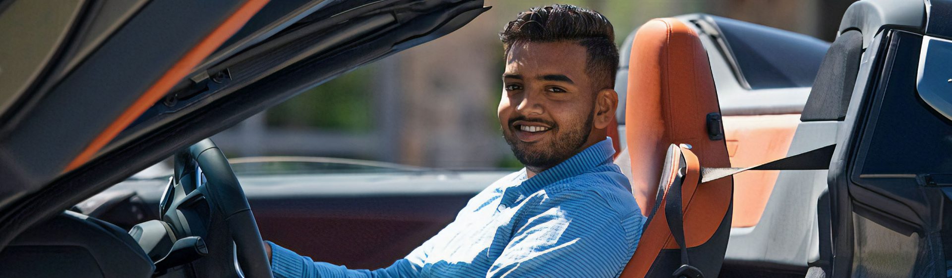 The image shows Azeem Shah, a Retail Marketing Specialist at BMW Group Canada, sitting in a car.