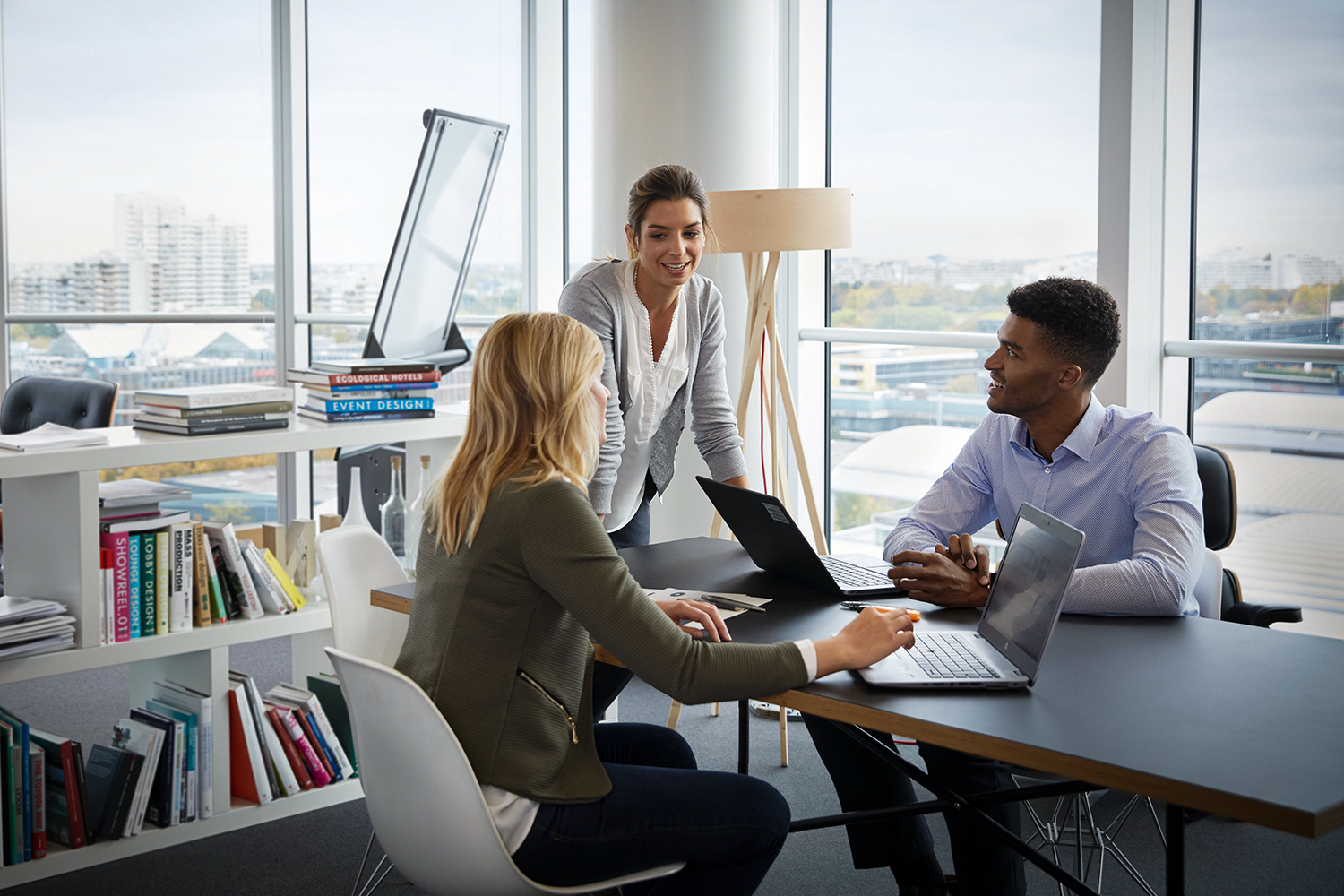Three legal colleagues discussing a topic in a meeting room