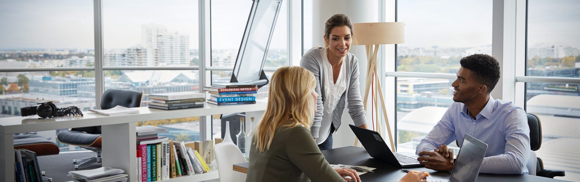 Three legal colleagues discussing a topic in a meeting room