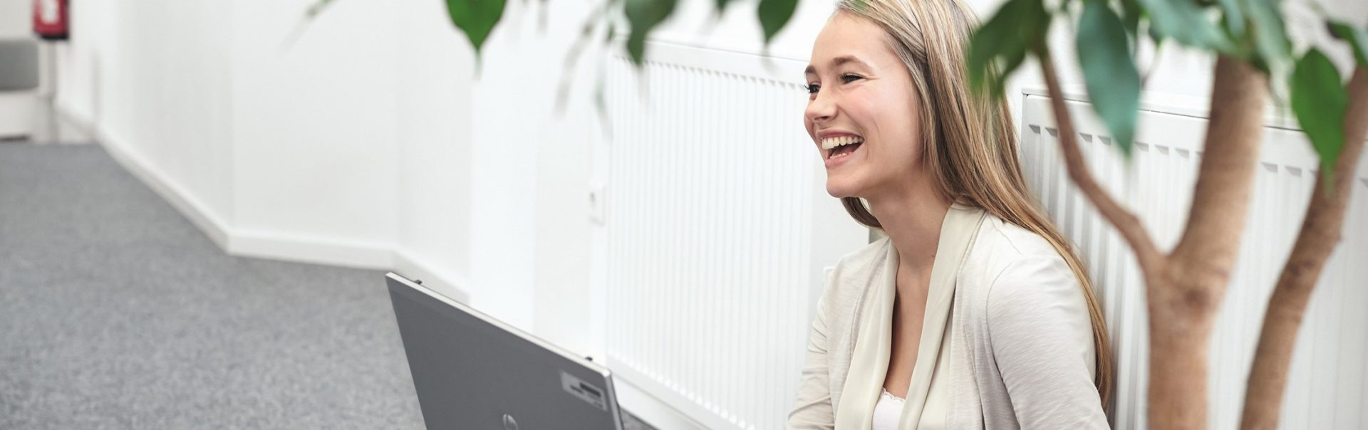 A female student works on a laptop and gains work experience at BMW.