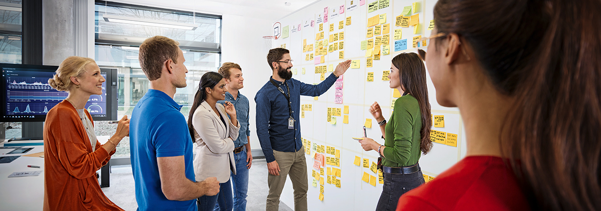 Seven colleagues analysing data on an agile project board