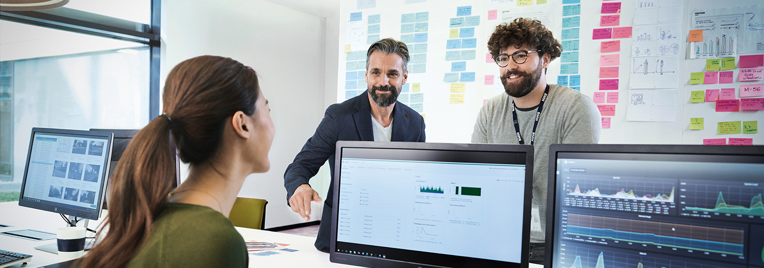 Three IT colleagues analysing data
