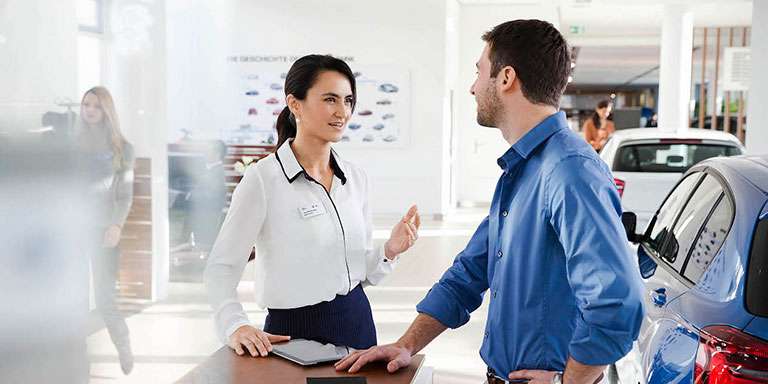 a woman and a man are talking in a Sales environment