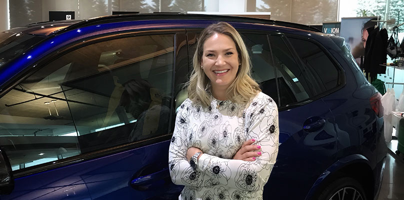 The image shows Holly Strobel, a Retailer CRM Systems Manager at the BMW Group Canada.