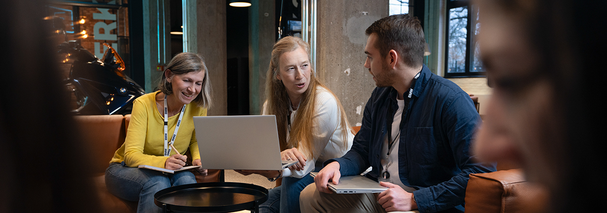 Three colleagues talking about benefits