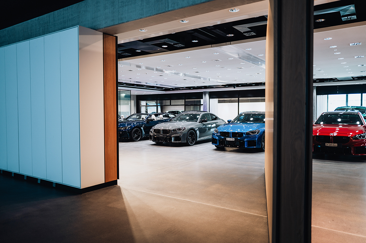 Headquarter Dielsdorf BMW Group showroom with various vehicles.