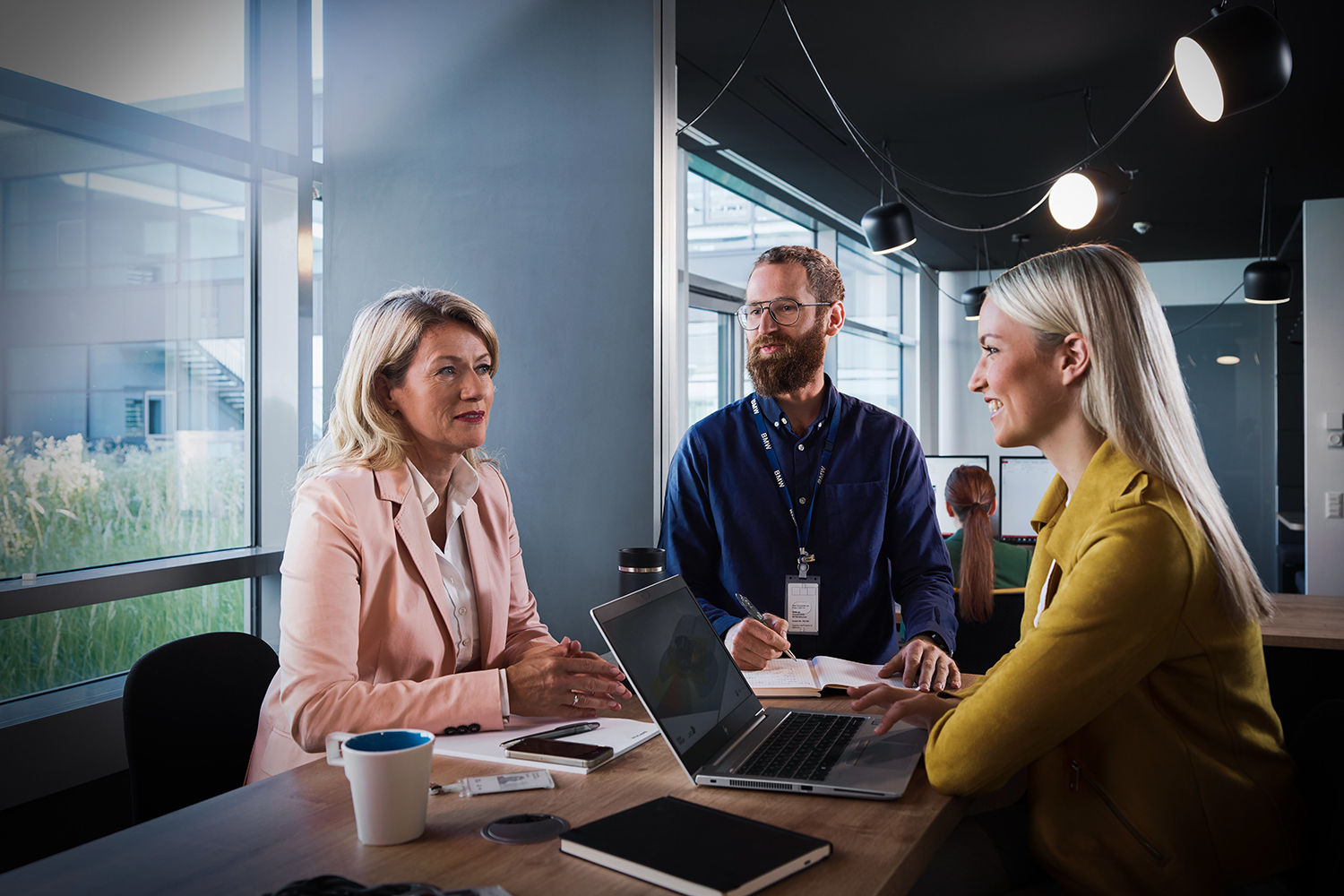 Three colleagues are having a collaborative conversation.