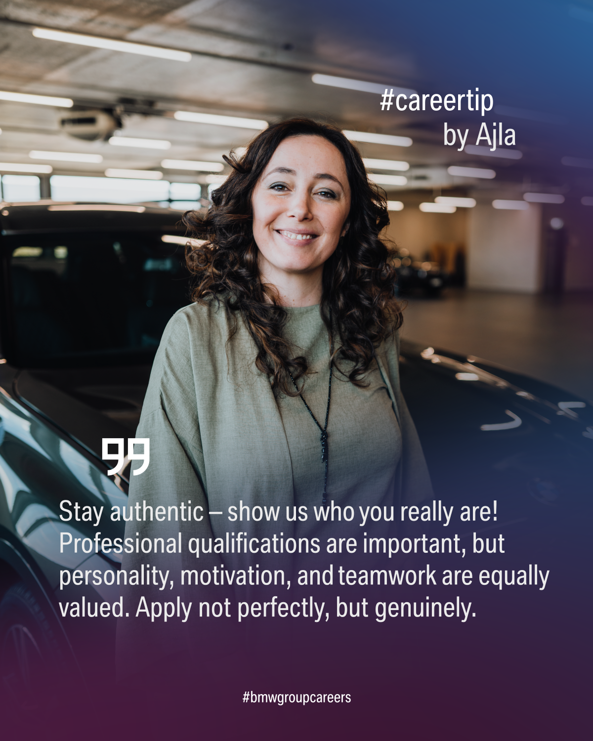 Female BMW employee is smiling at the camera.