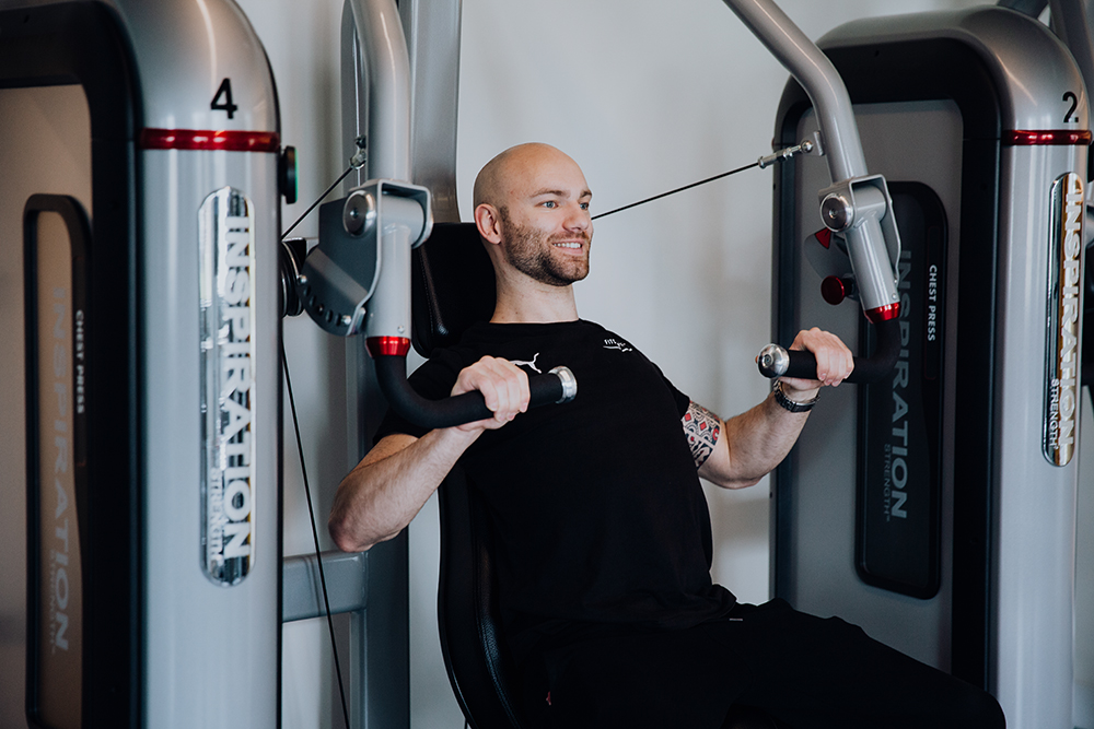A man is training in a gym.