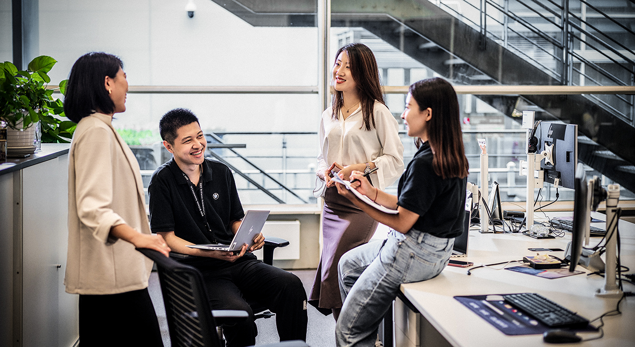 A group of young people are having a conversation in an innovative working environment.