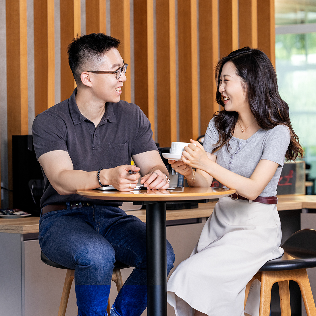 The picture shows two students working together at BMW.