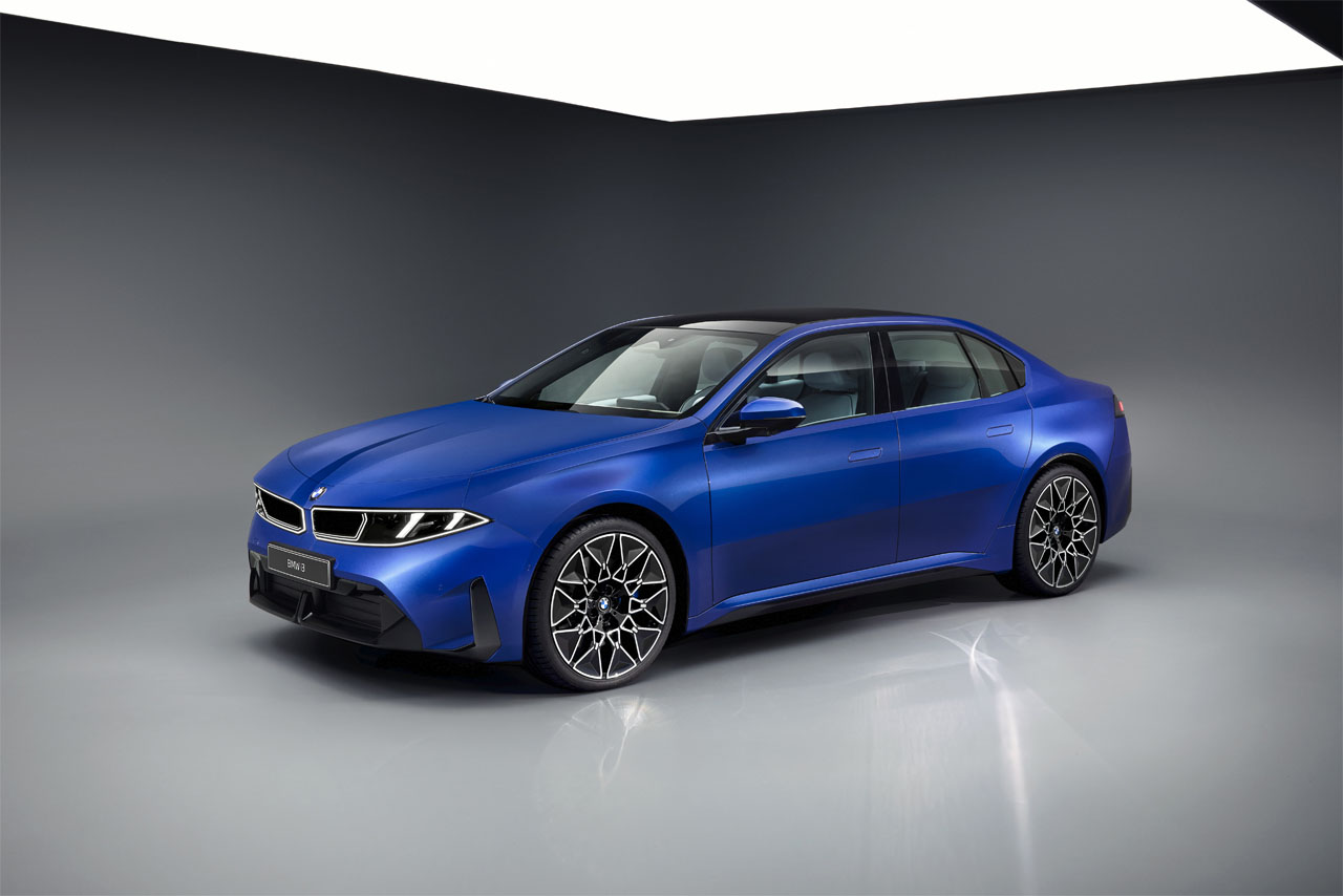A blue BMW 3 Series with sporty rims, photographed from an oblique front angle in a bright photo studio.