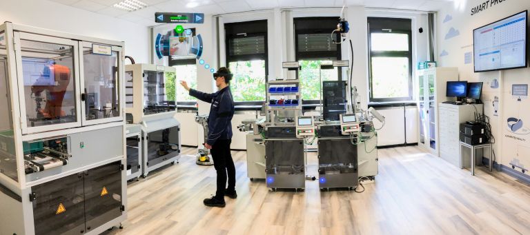 Apprentice testing a product in the “Smart Factory” at the plant in Berlin