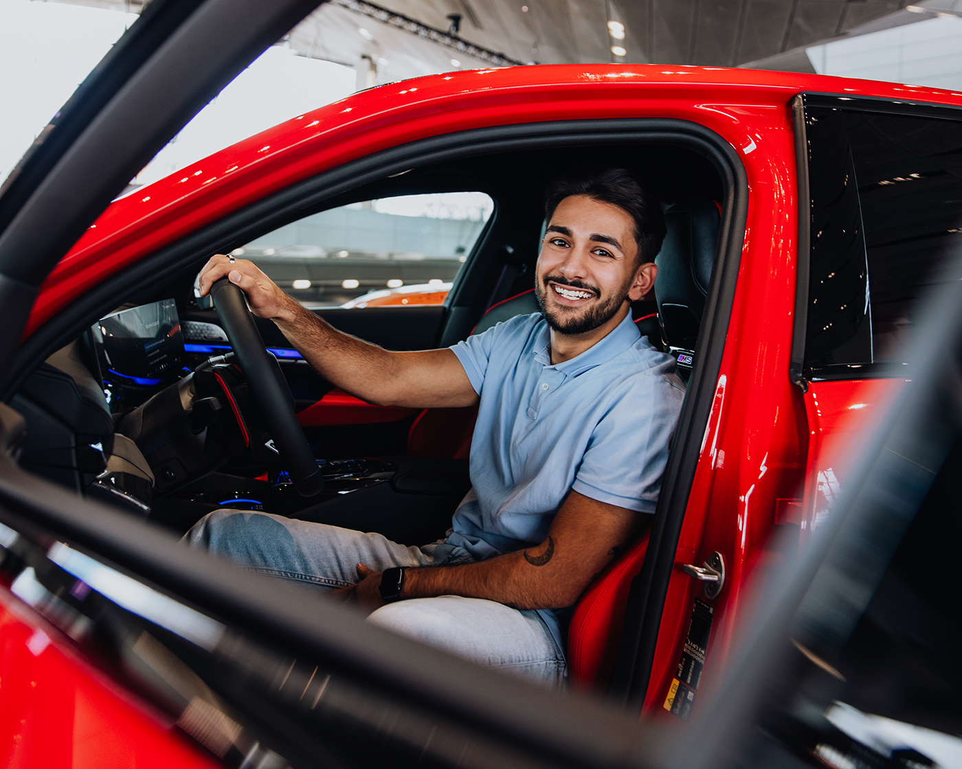 Yasar in front of a BMW M5.