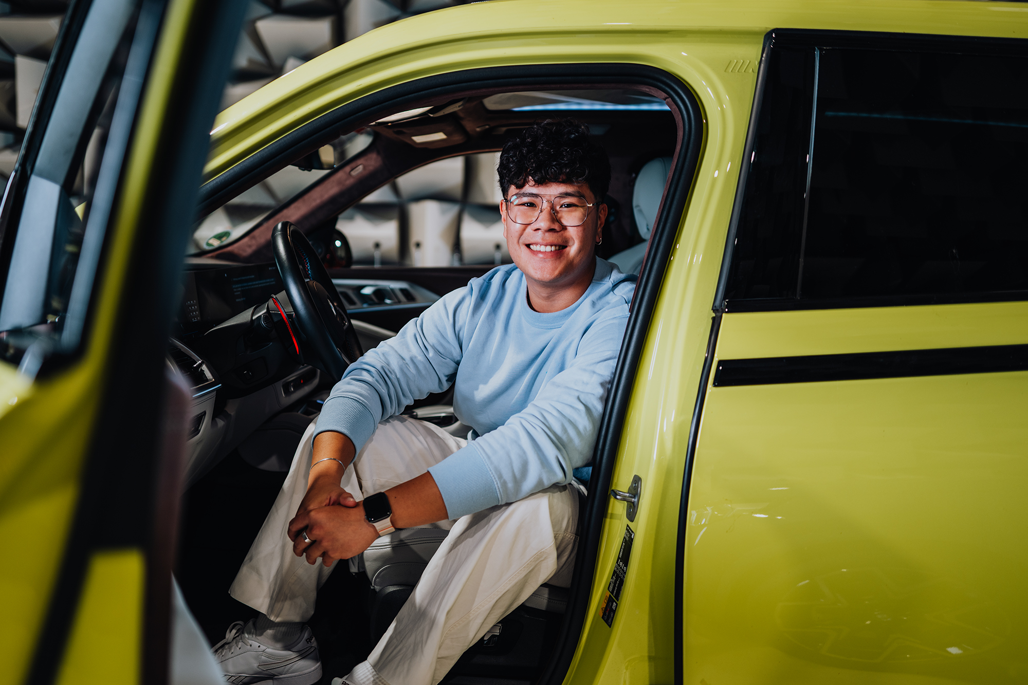 Yian in the drivers seat of a BMW XM.