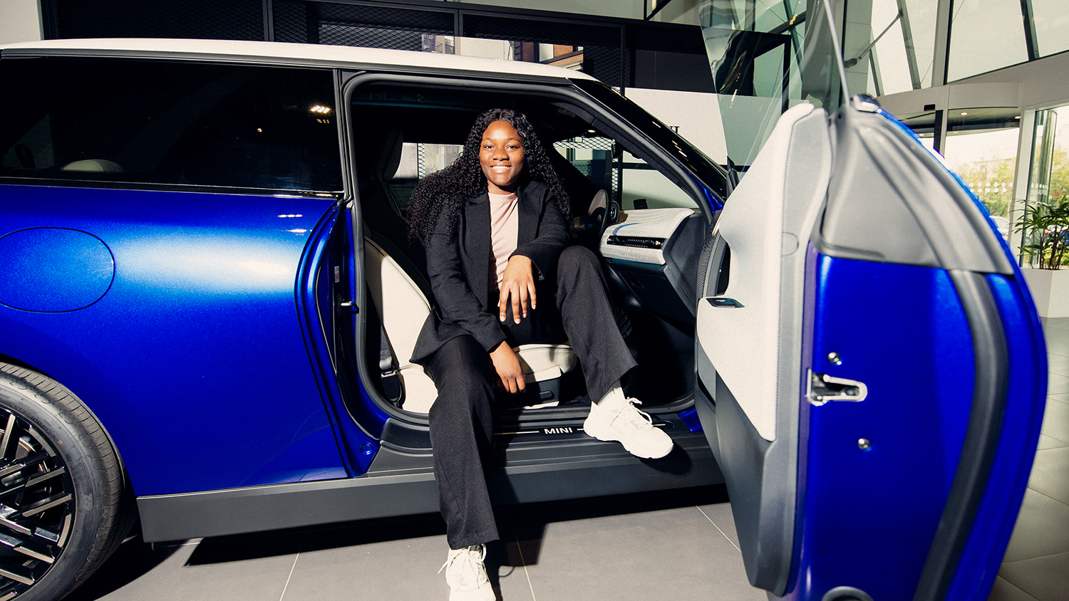 One of BMW Group's interns in a blue MINI