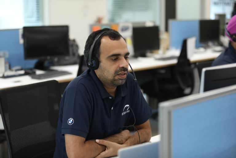 The picture shows a BMW Group employee in a call.