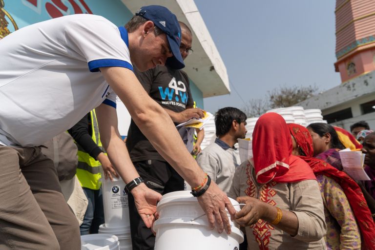 BMW employees distributing water filters.