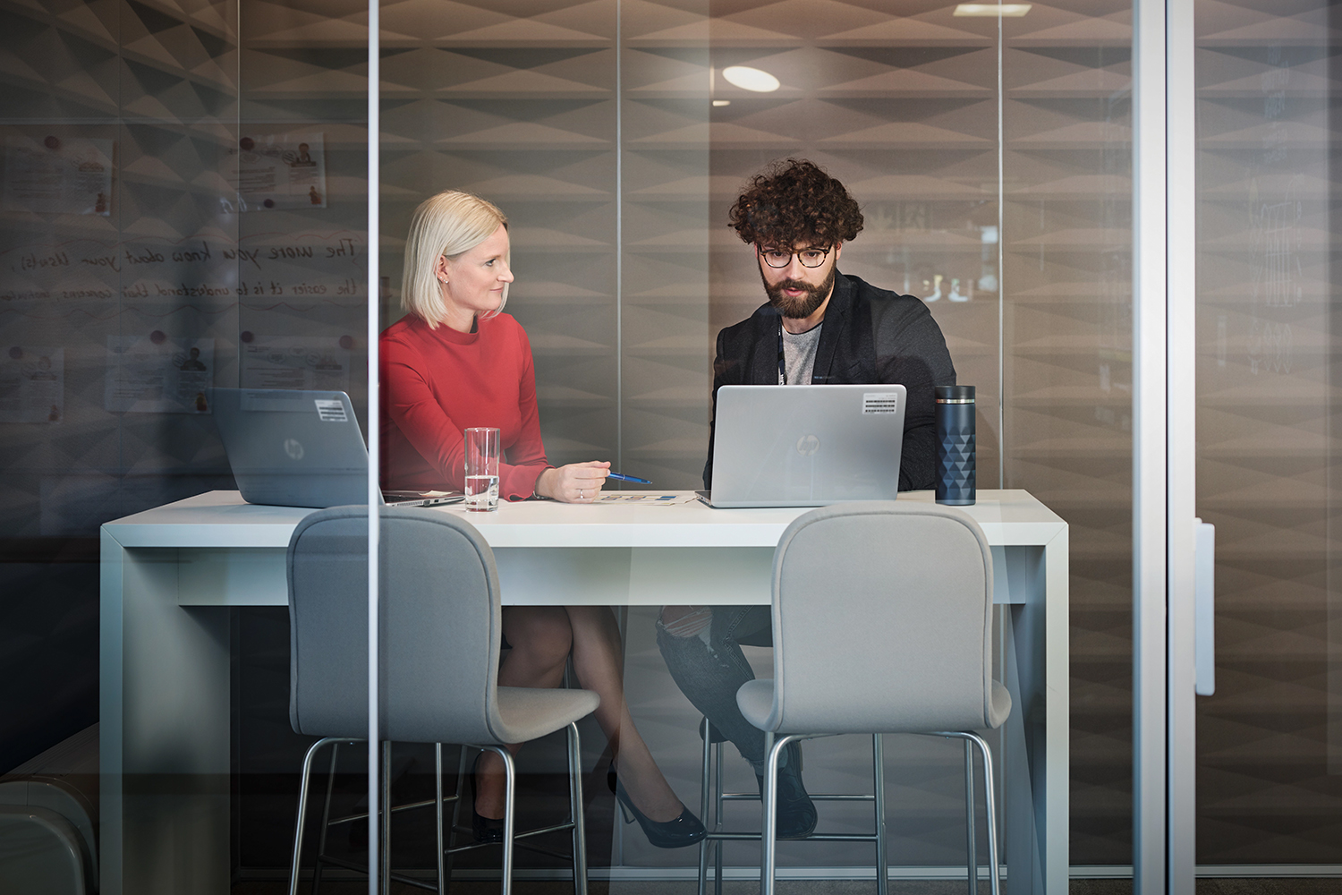 Two colleagues are having a chat in a meeting room
